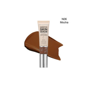 Tube of skin serum foundation labeled 'Sensitive Skin Serum' with a mocha-brown swatch behind; shade N06 Mocha.