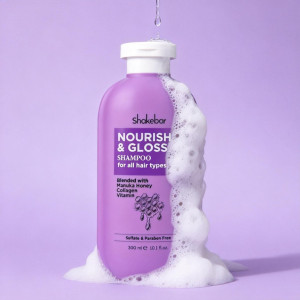 Purple Shakebar Nourish & Gloss shampoo bottle with white foam around base, set against lavender backdrop.
