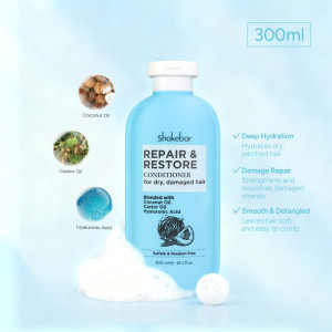 Blue Shakebar Repair & Restore conditioner bottle (300 ml) for dry, damaged hair, with icons for coconut oil, castor oil, and hyaluronic acid and a foamy base.